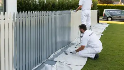 Fence painting in Bakersfield, CA by Bakersfield Paint Pros protecting and beautifying a wood fence